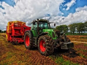 Tractor disposing hazardous waste on a farm